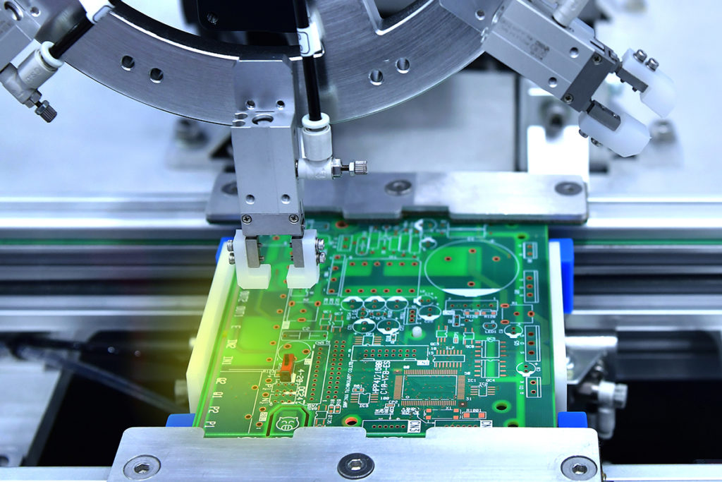 Automated factory equipment soldering and assembling chip components.