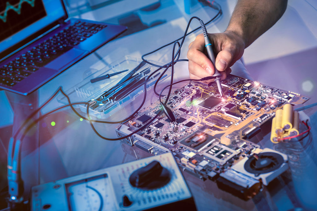 Technician testing electromechanical components