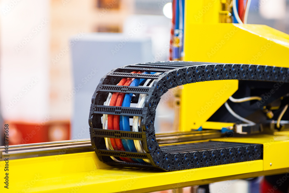 Plastic cable chain housing cable assemblies in an automated machine