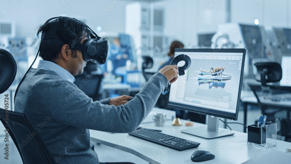 Mechanical Engineer wearing virtual reality headset designing prototypes for a Smart Factory