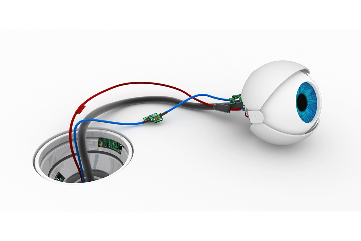 Robotic round eyeball with a multi-function cable attached, displayed on a white surface socket