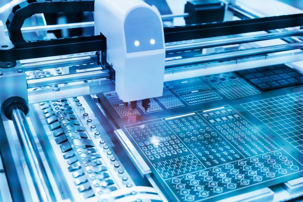 PCB Processing on a CNC machine during the production of electronic components at a high-tech factory.