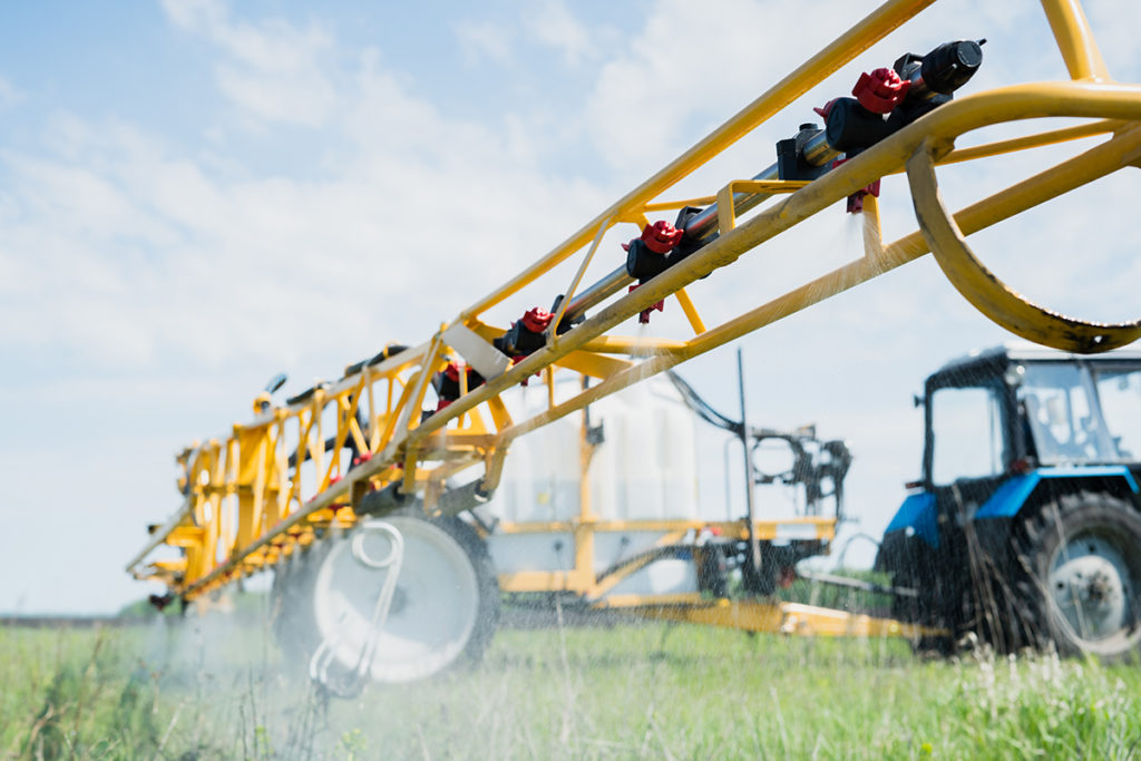 Farm equipment spraying field automated sensor technology.