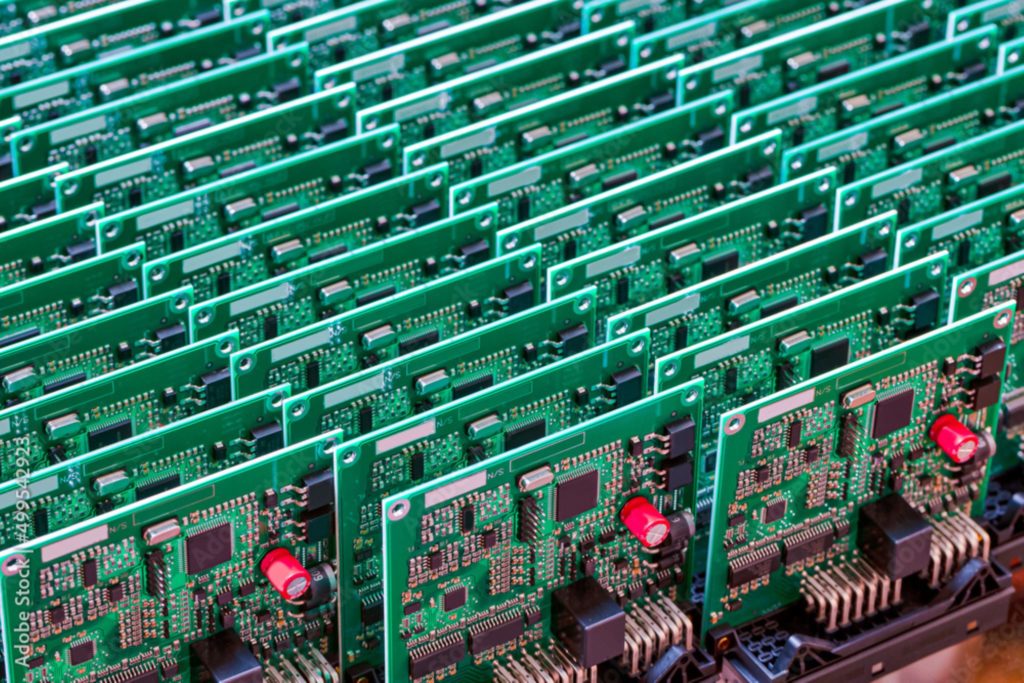 Close up of line batch of printed circuit boards with placed soldered surface mounted components