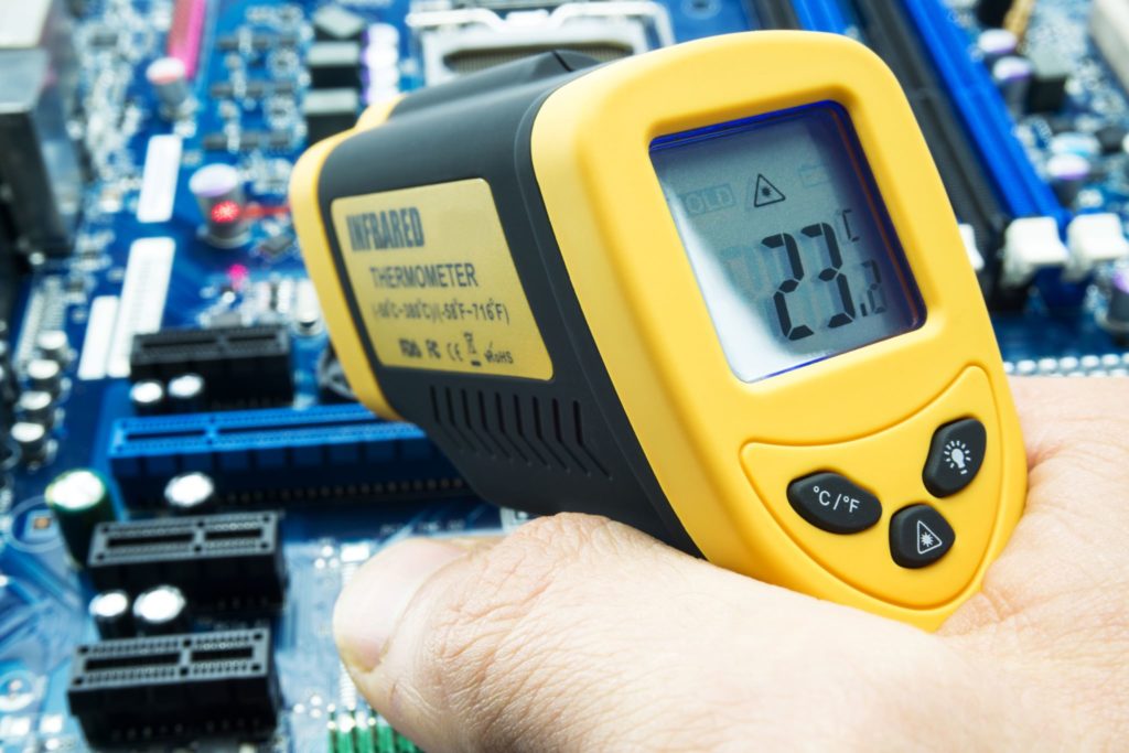 Infrared thermometer being used for environmental testing in a medical box build assembly