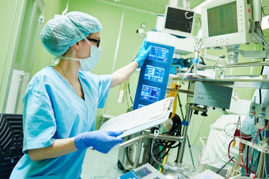 Surgery assistant perfusionist operating amodern heart lung machine utilizing medical interconnect solutions.