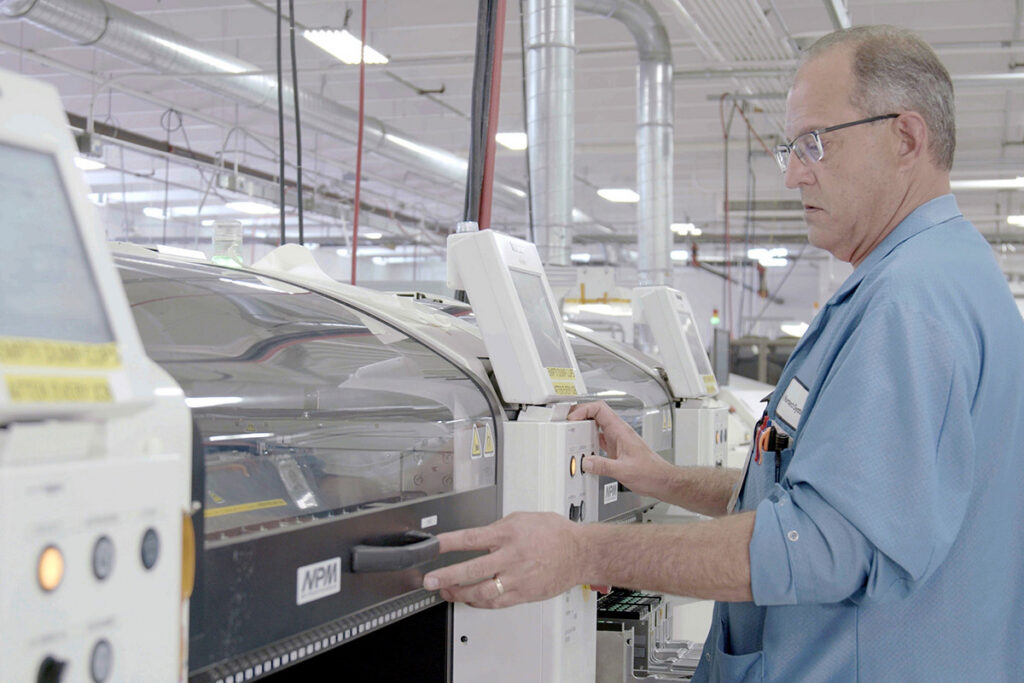 Nortech employee operates custom PCBA testing and validation equipment