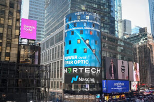 A Power Over Fiber billboard in Times Square highlights a modern approach to power and data transmission using optical fiber instead of copper cabling.