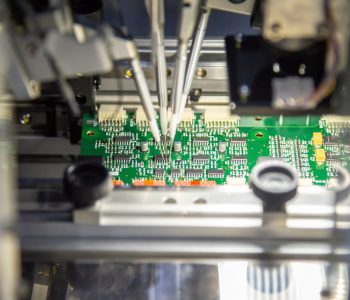 The production line of electronic board with microchip in the light blue scene.The electronics board production process.