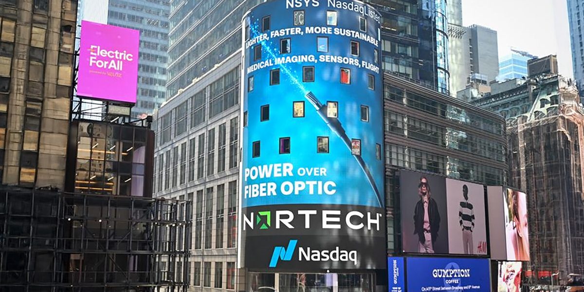 A Power Over Fiber billboard in Times Square highlights a modern approach to power and data transmission using optical fiber instead of copper cabling.